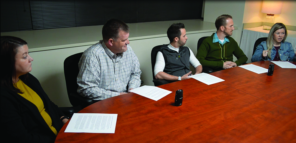 Image of people sitting around a conference table