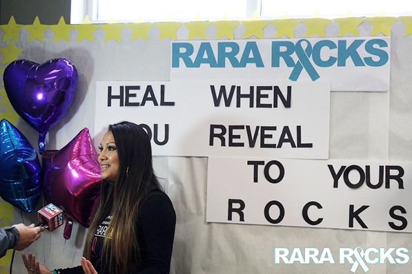 The coordinator of the Rara Rocks event speaks to someone off-camera.