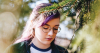 Teen girl wearing glasses with hair dyed purple