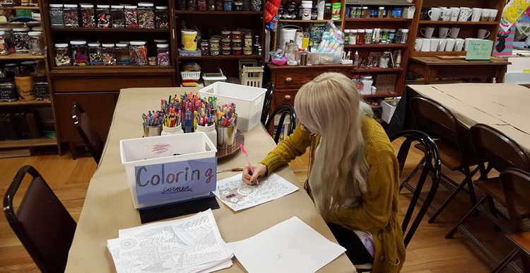 Women coloring with pink pencil inside art studio