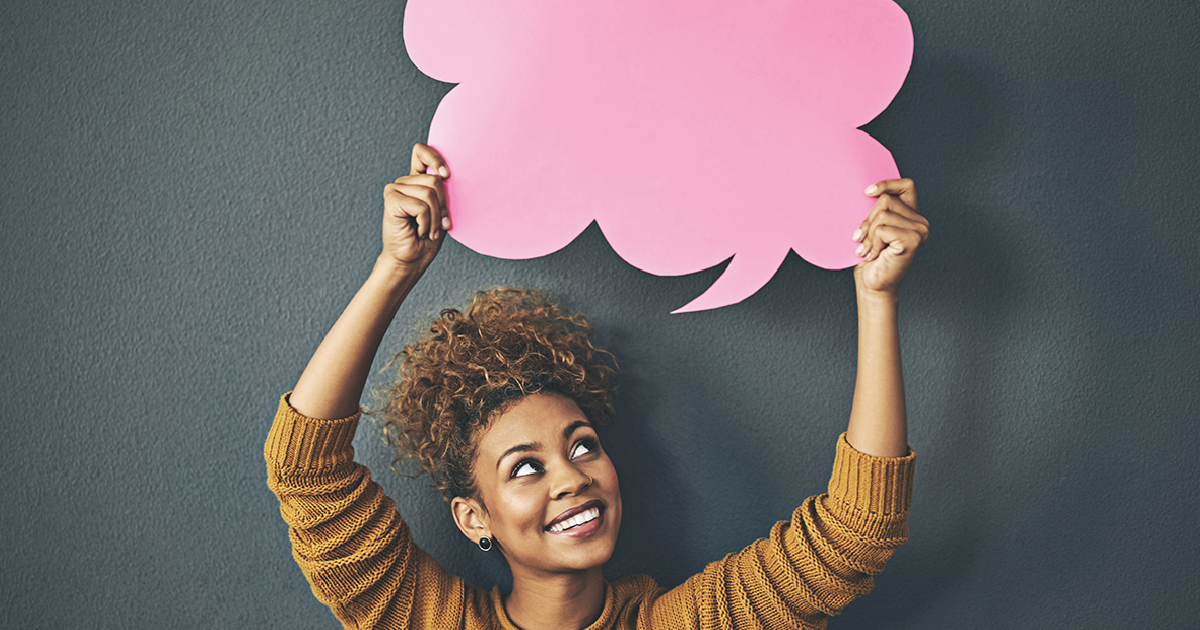 Young woman holding up a speech bubble