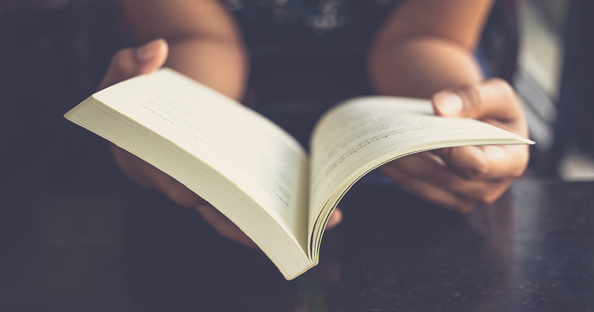 Person holding open a book