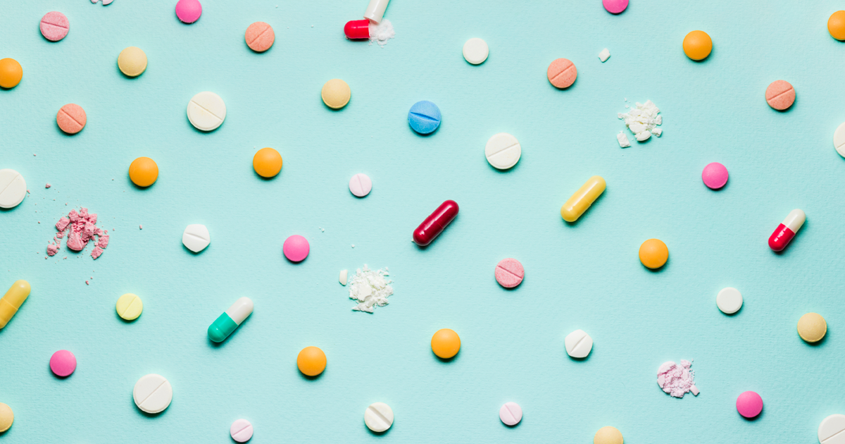 Various pills against a light blue background