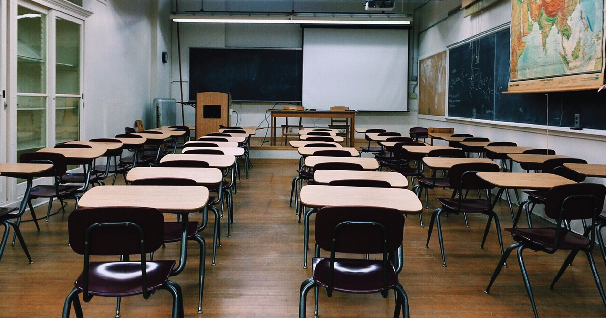 Rows of desks in an empty classroom