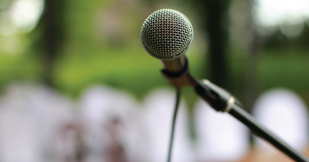 Up-close shot of a microphone pointed toward the reader