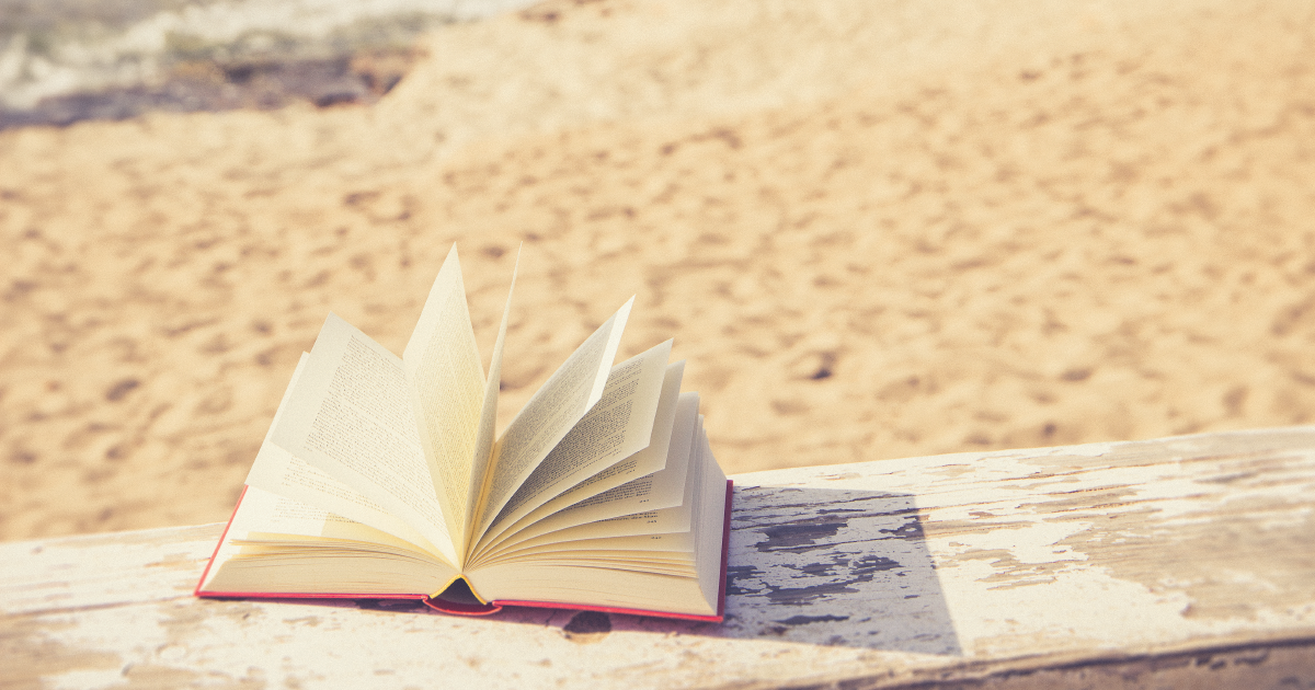 Book lying open with the beach in the background