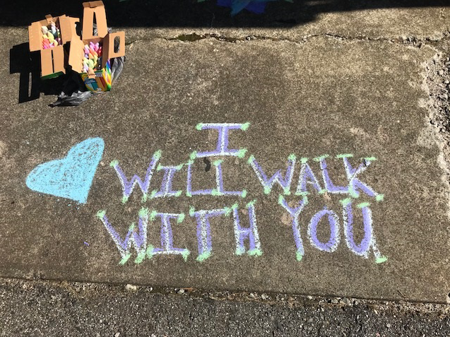 Sidewalk chalk with the message "I will walk with you."