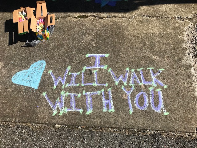 Chalk words say "I will walk with you"