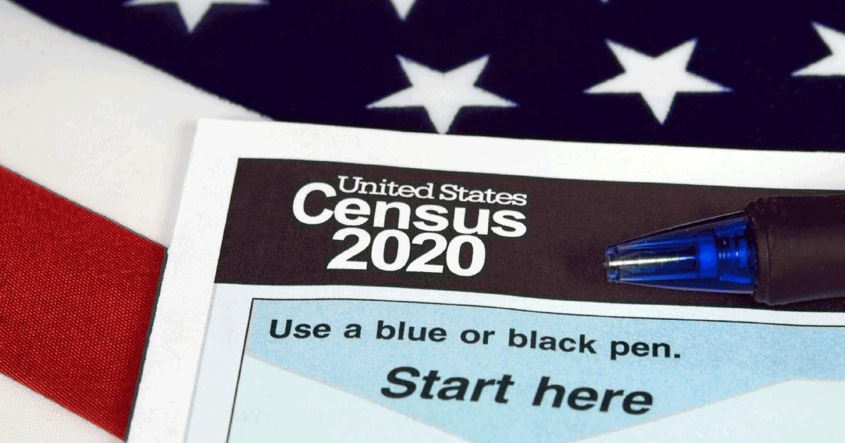 Paper version of the 2020 US Census against an American flag