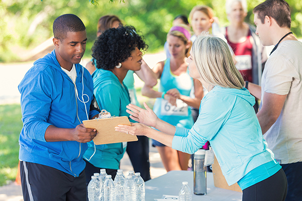 Volunteers signing people in at a relay race