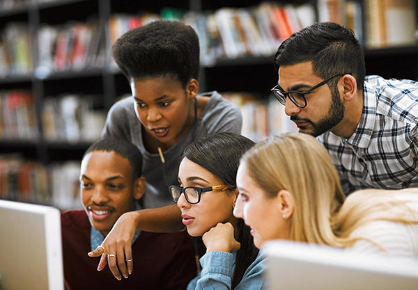 Group of students looking at a computer