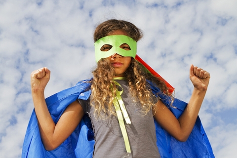 Young girl in a superhero costume 