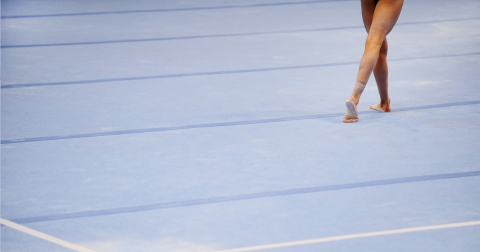 Feet of a girl on a gymnastics mat
