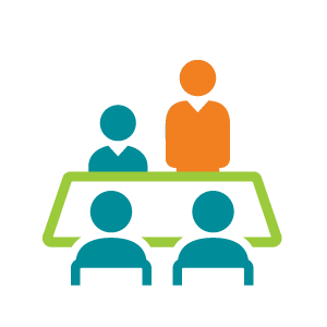 picture of three people sitting at table and one person standing