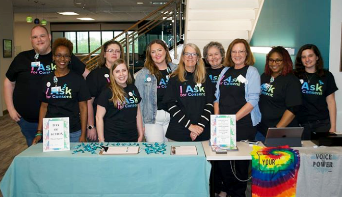 Group standing behind a table at event