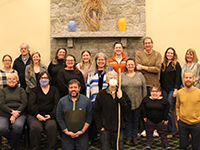 group photo of members of disability rights maine infront of a brick fireplace